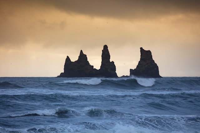Basalt columns and black sand at Reynisfjara Beach in Iceland